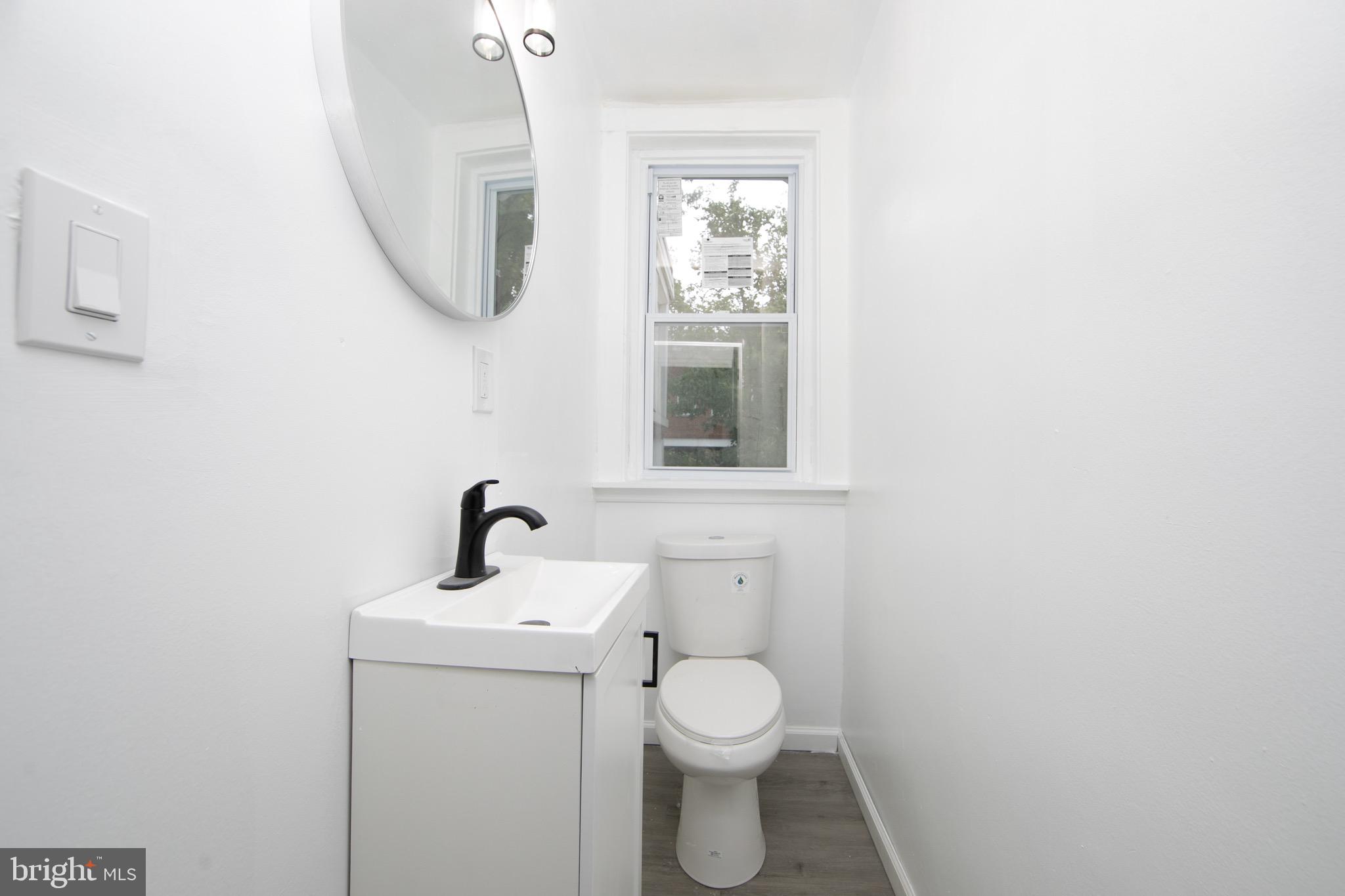 1261 South Merrimac Road Camden, NJ 08104 - Photo 8 of 27 a bathroom with a toilet sink and mirror