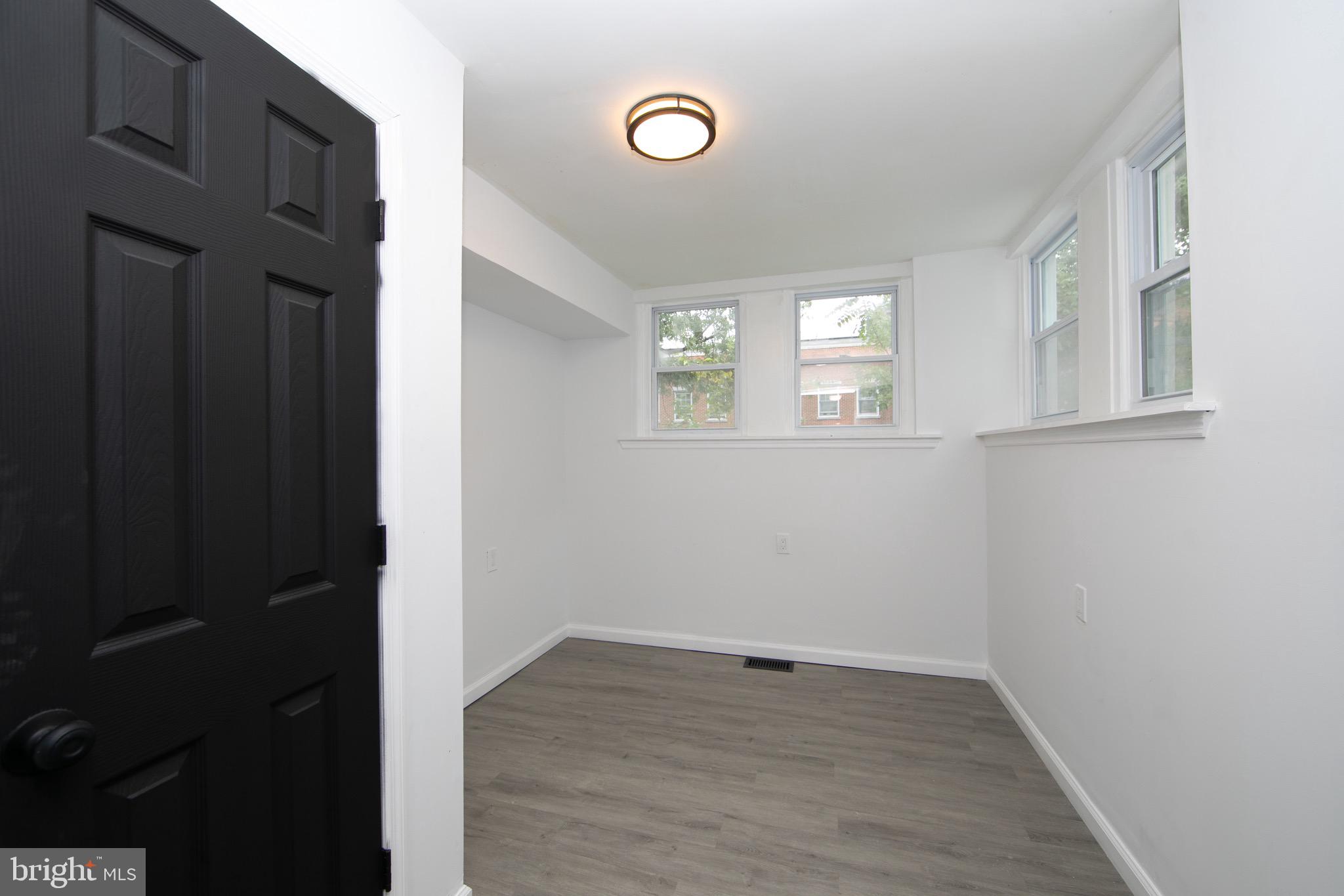 1261 South Merrimac Road Camden, NJ 08104 - Photo 9 of 27 an empty room with wooden floor and window