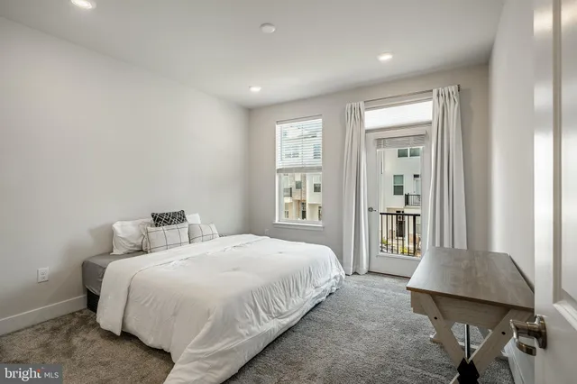 a spacious bedroom with a bed and a desk