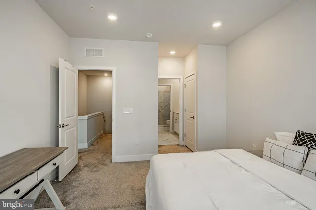 a spacious bedroom with a bed and a table in it