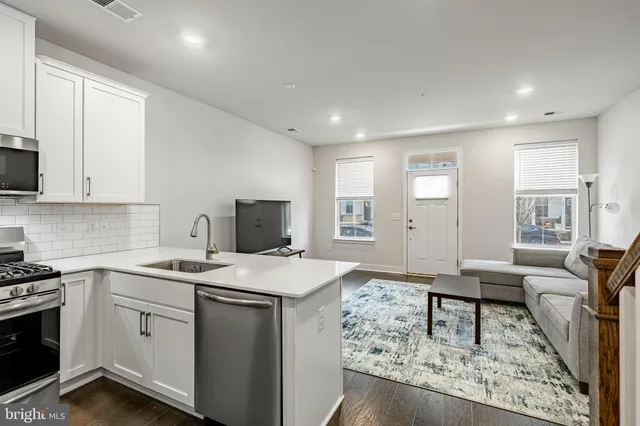 a view of kitchen with sink microwave and stove