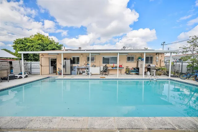 a view of a swimming pool with outdoor seating
