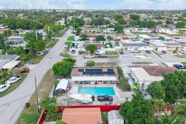 an aerial view of residential houses with outdoor space