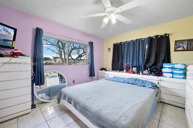 a bedroom with a bed dresser and a window