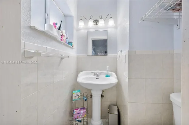 a bathroom with a sink a mirror and a shower