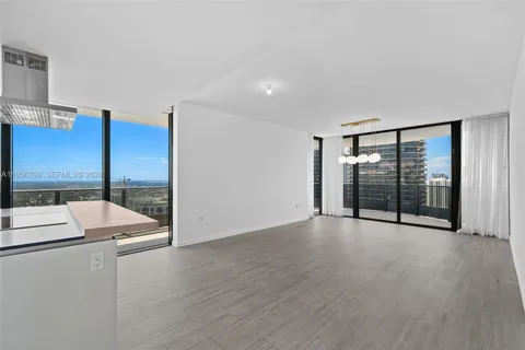 a view of an empty room with glass door