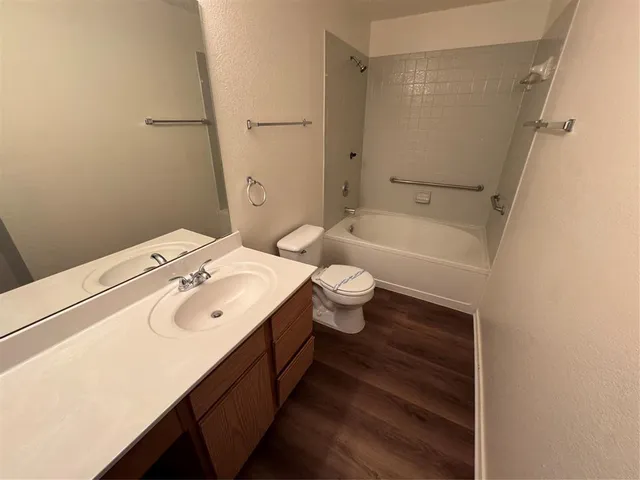 en empty room with windows and fan