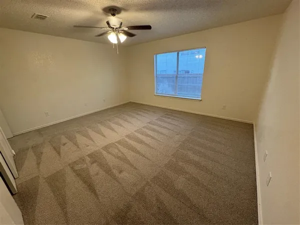 a view of a livingroom with a ceiling fan and window