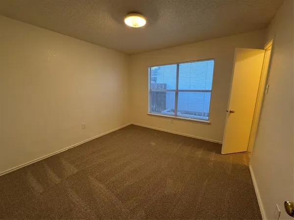 a view of backyard with seating and wooden fence