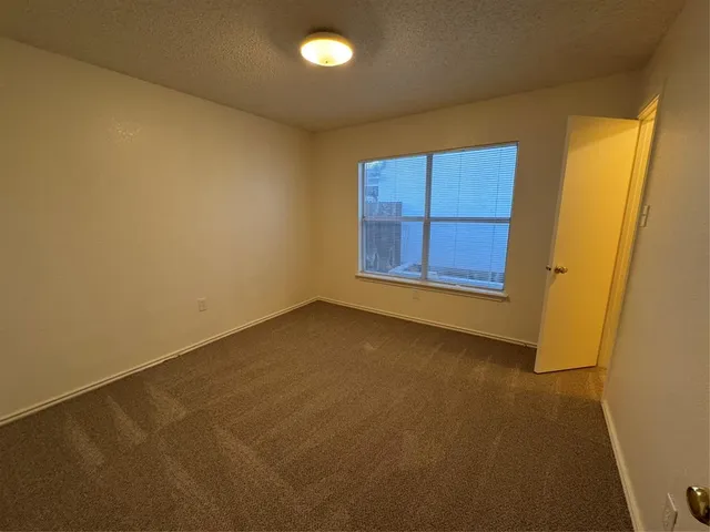 a view of backyard with seating and wooden fence