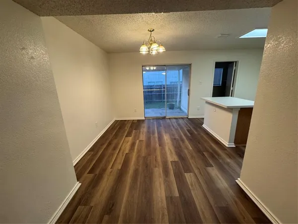 a view of wooden floor and a chandelier
