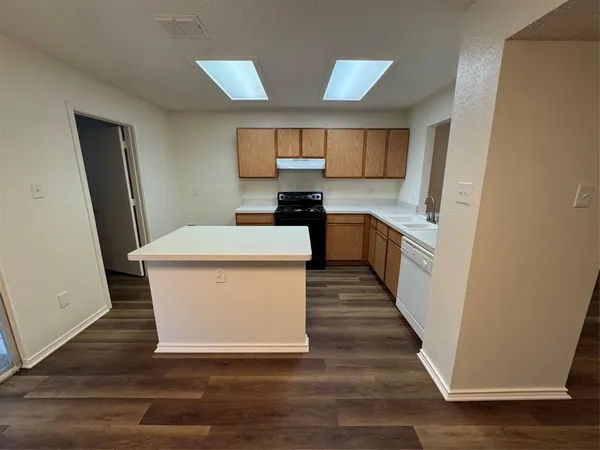 a kitchen with stainless steel appliances a white stove top oven and sink