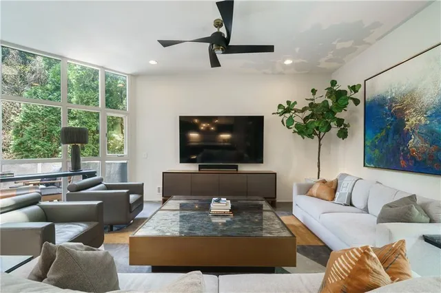 a kitchen with stainless steel appliances granite countertop a sink a stove and a wooden floors