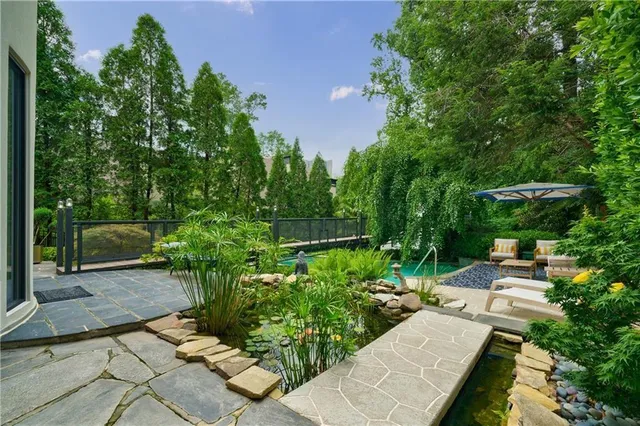 an outdoor sitting area with furniture and umbrella