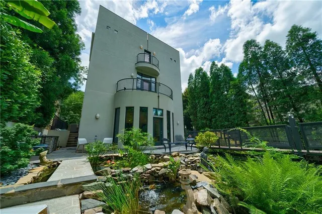 a bedroom with a bed a window and flat screen tv