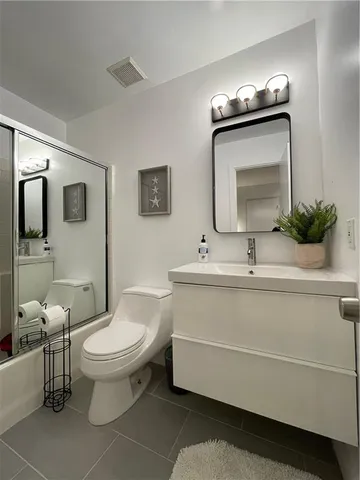 a view of a kitchen with granite countertop a refrigerator and a sink