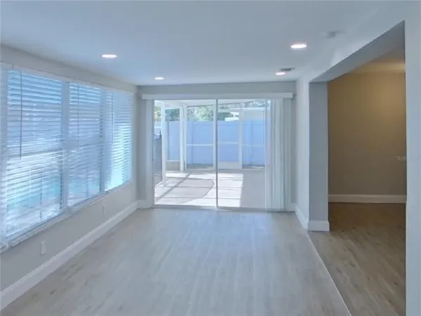 a view of wooden floor and windows in a room