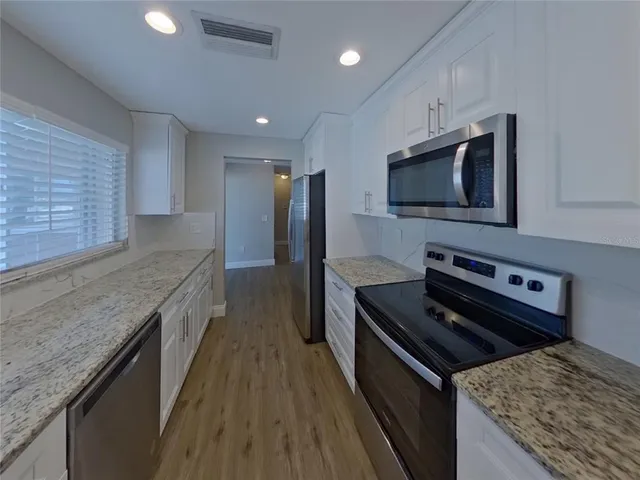a kitchen with a stove and a microwave