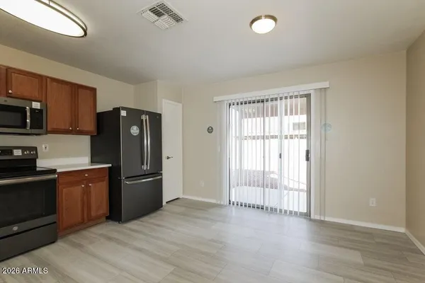 a kitchen with stainless steel appliances granite countertop a refrigerator stove and sink