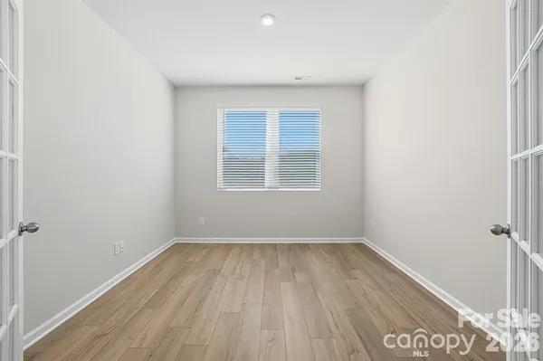 a view of a room with wooden floor and window