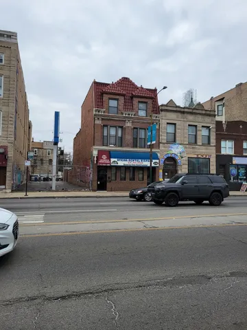 a city street with tall buildings and a cars parked in front of it