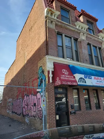 a car parked in front of a big house