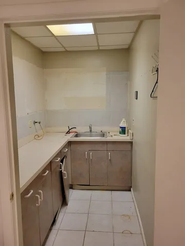 a utility room with a sink washer and dryer