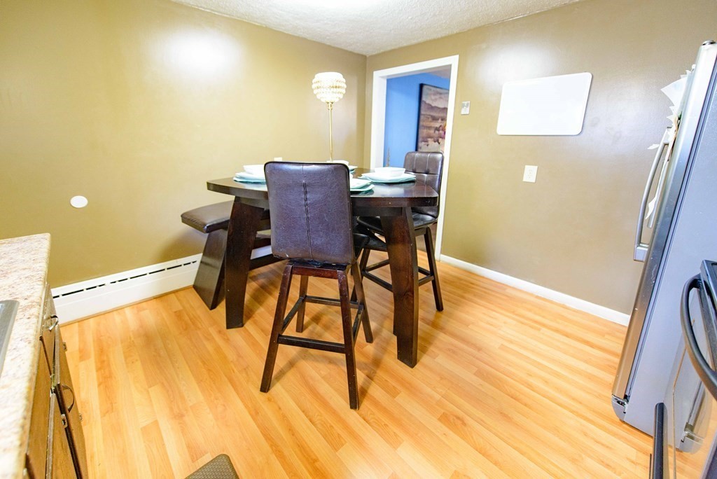 99 Merrill Road Springfield, MA 01119 - Photo 11 of 30 a view of a dining room with furniture and wooden floor