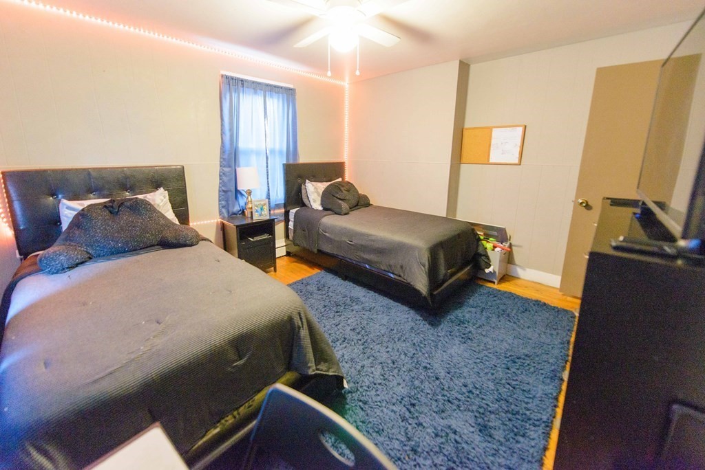 99 Merrill Road Springfield, MA 01119 - Photo 13 of 30 a bedroom with two beds and wooden floor