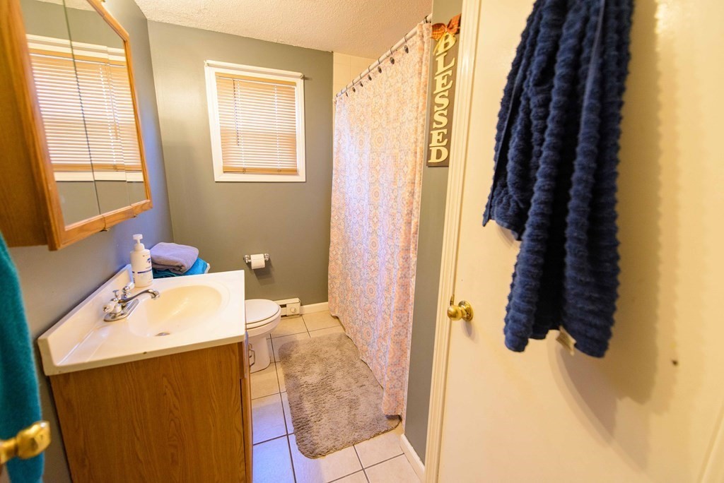 99 Merrill Road Springfield, MA 01119 - Photo 19 of 30 a bathroom with a tub sink and mirror