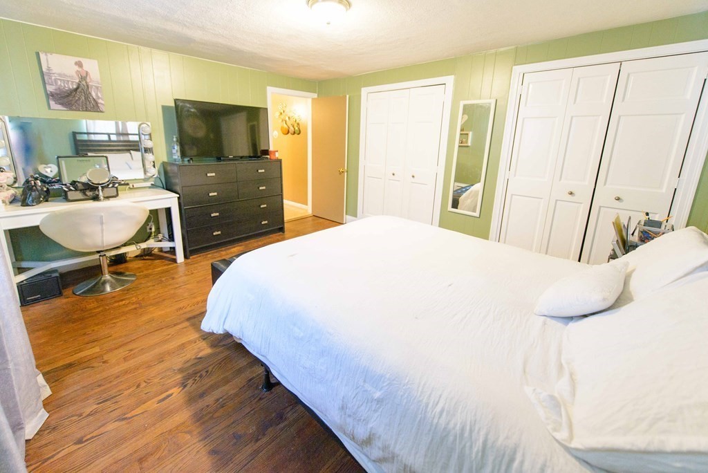 99 Merrill Road Springfield, MA 01119 - Photo 23 of 30 a spacious bedroom with a bed and a flat screen tv