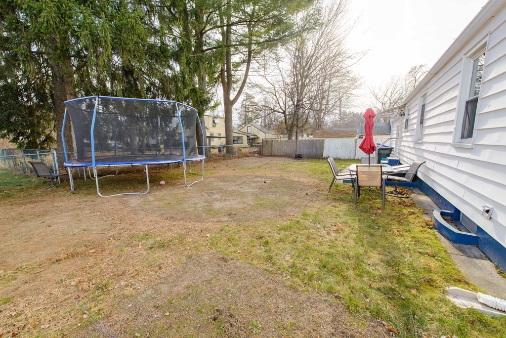 99 Merrill Road Springfield, MA 01119 - Photo 28 of 30 a backyard of a house with table and chairs