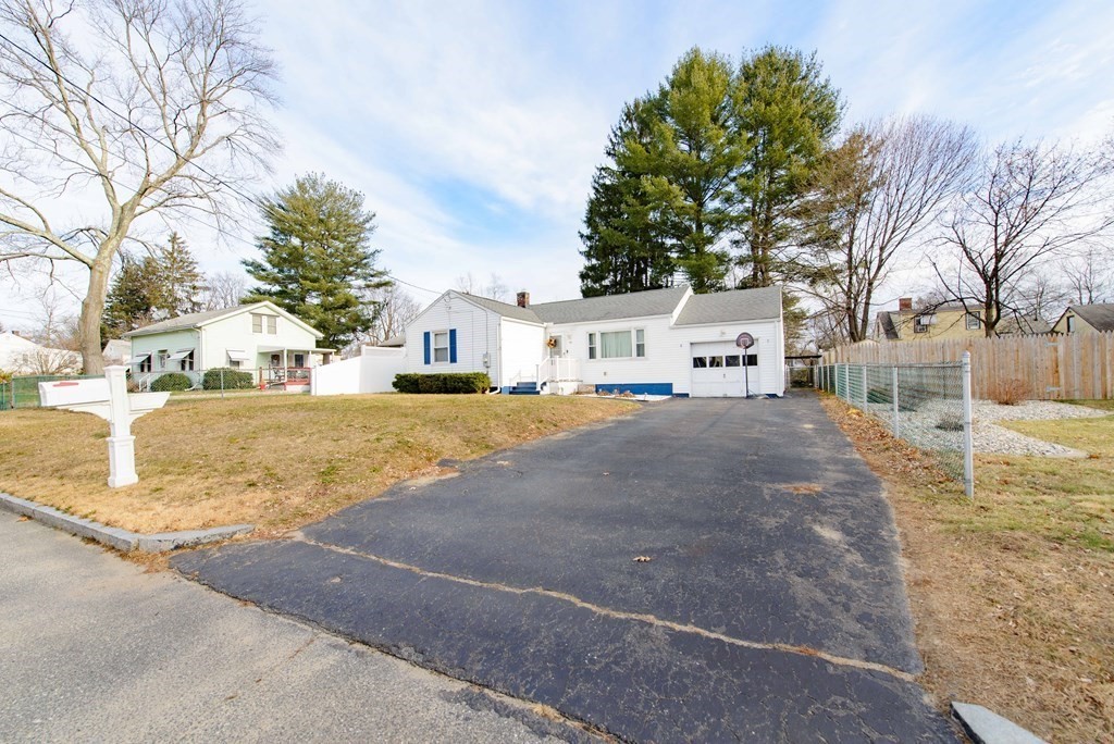 99 Merrill Road Springfield, MA 01119 - Photo 3 of 30 a view of a white house with a yard covered in snow