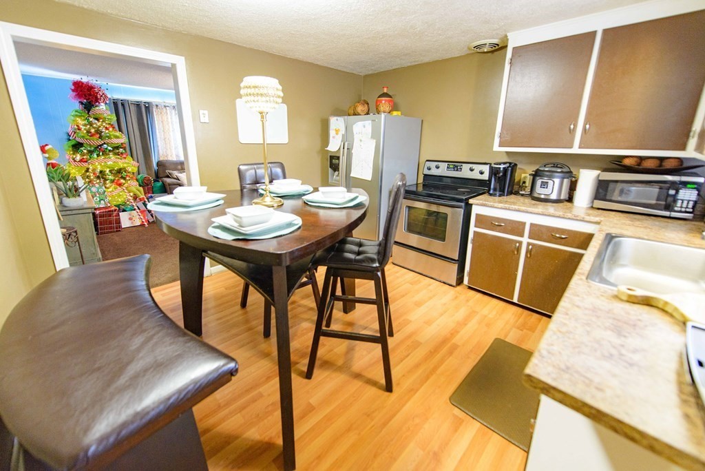 99 Merrill Road Springfield, MA 01119 - Photo 8 of 30 a view of a dining room with furniture and a kitchen
