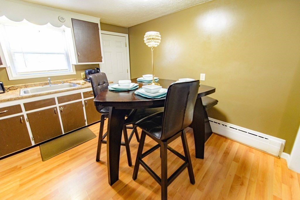 99 Merrill Road Springfield, MA 01119 - Photo 10 of 30 a view of a dining room with furniture and wooden floor