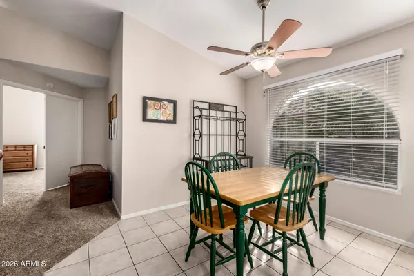a living room with furniture a ceiling fan and a rug