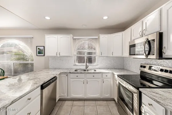 a view of a dining room with furniture and a window