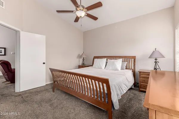 a living room with furniture a flat screen tv and a window