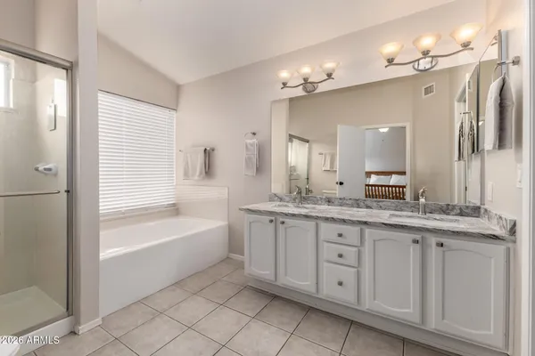 a bedroom with a bed and ceiling fan