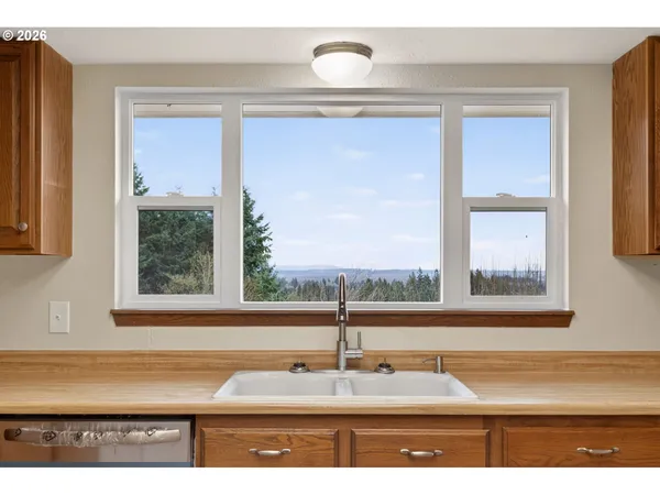 a bathroom with a window and a sink