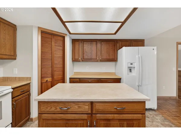 a kitchen with cabinets and wooden floor