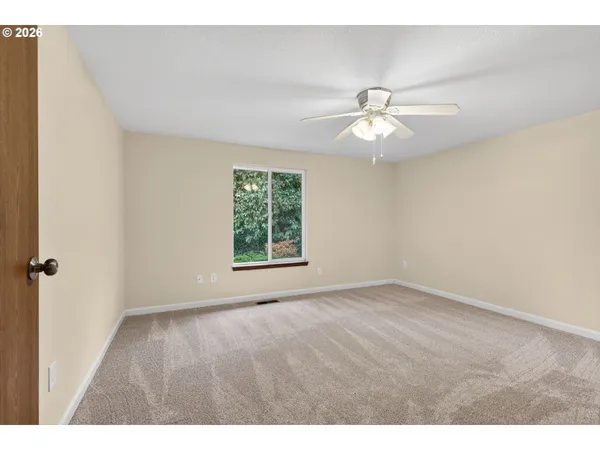 a view of room with a ceiling fan and window