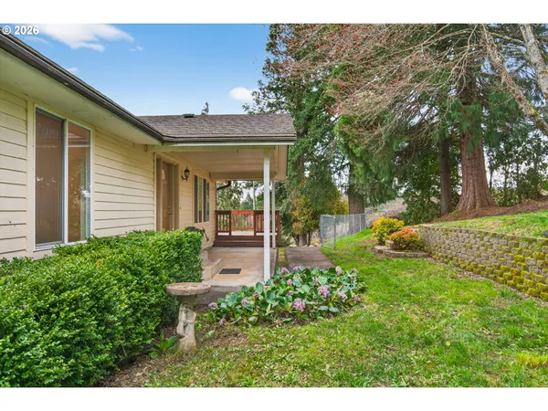 a view of a house with backyard and sitting area