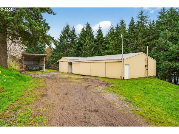 a backyard of a house with plants and wooden fence