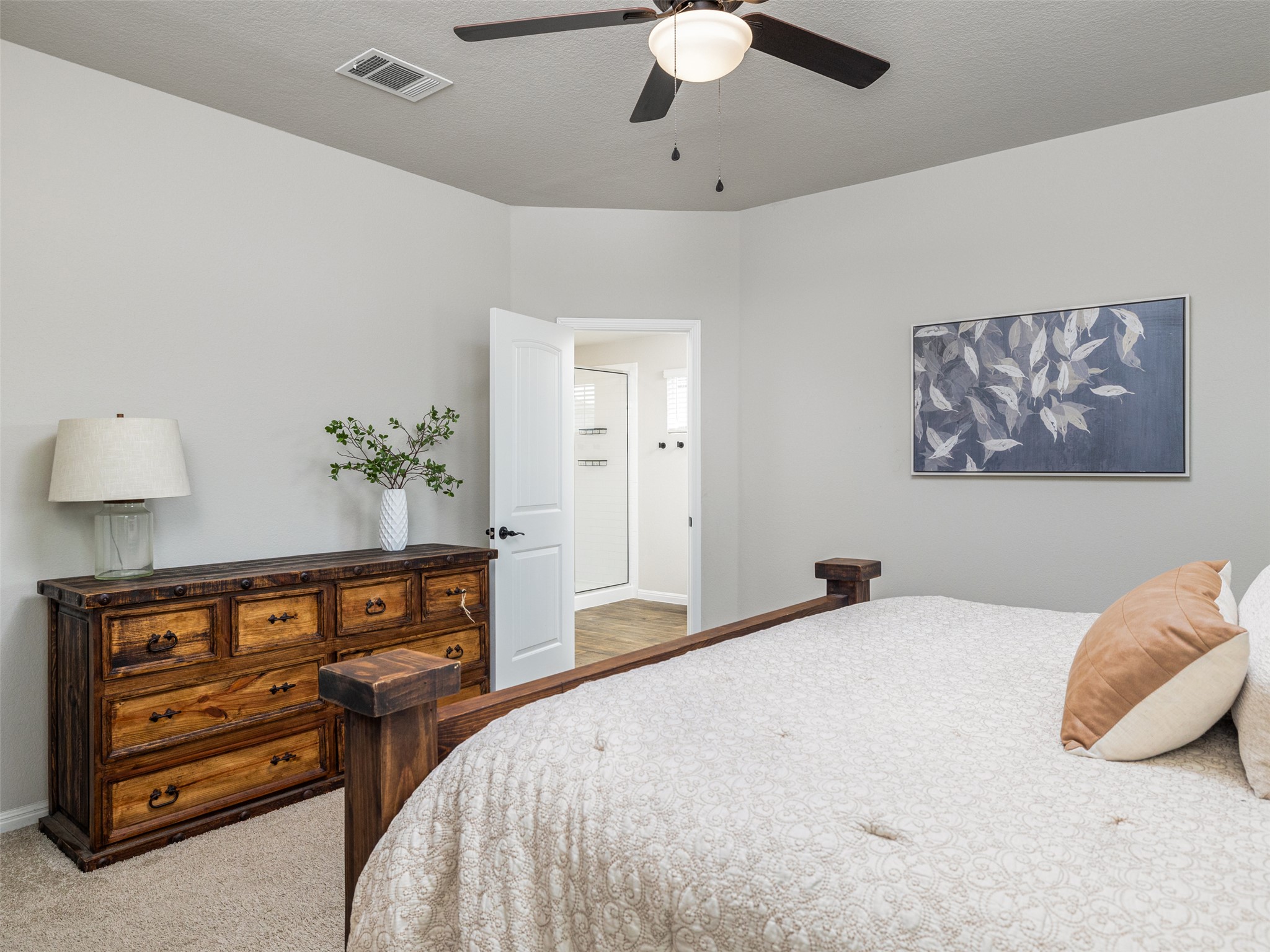 439 Hunter Loop Bertram, TX 78605 - Photo 14 of 23 A restful bedroom offers a private retreat with soft carpeting and an adjoining bath.