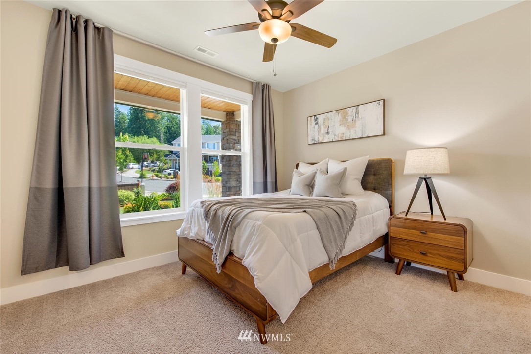 27418 Northeast 152nd Court Duvall, WA 98019 - Photo 15 of 40 a spacious bedroom with a bed and a window