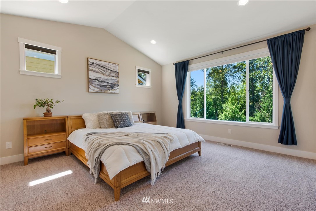 27418 Northeast 152nd Court Duvall, WA 98019 - Photo 18 of 40 a spacious bedroom with a bed and a large window