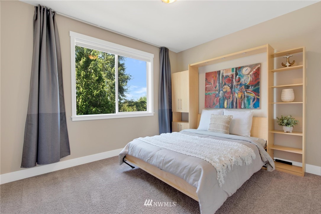27418 Northeast 152nd Court Duvall, WA 98019 - Photo 21 of 40 a bedroom with a large bed and a window