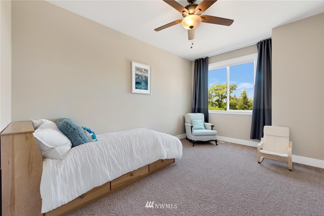 27418 Northeast 152nd Court Duvall, WA 98019 - Photo 22 of 40 a bedroom with a bed and a chandelier