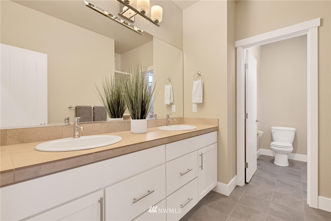 27418 Northeast 152nd Court Duvall, WA 98019 - Photo 23 of 40 a spacious bathroom with a double vanity sink a mirror and a toilet